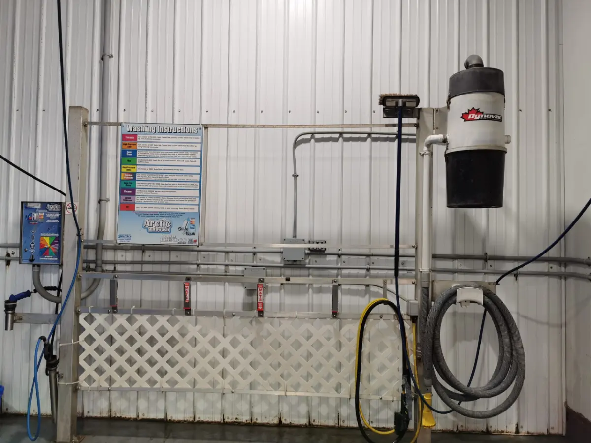 Wash wand and vacuum station in a self-serve bay at Arctic Autowash